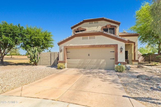 view of front of property with stucco siding, fence, concrete driveway, and a garage
