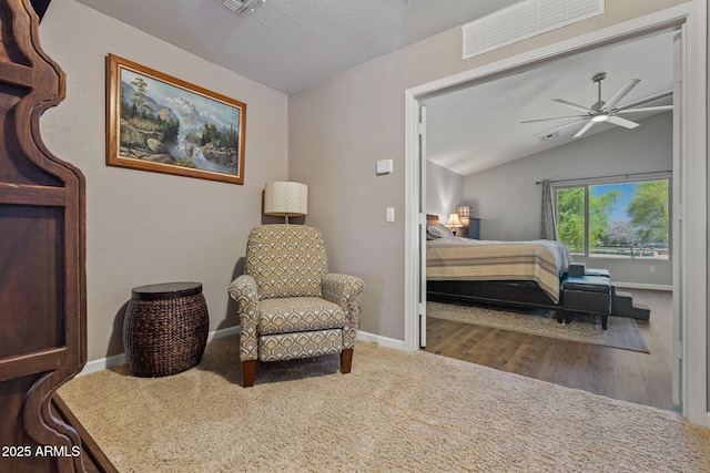 sitting room with lofted ceiling, ceiling fan, baseboards, wood finished floors, and carpet flooring
