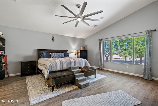 bedroom featuring wood finished floors, baseboards, lofted ceiling, and a ceiling fan