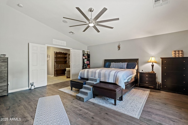 bedroom featuring vaulted ceiling, wood finished floors, baseboards, and a ceiling fan
