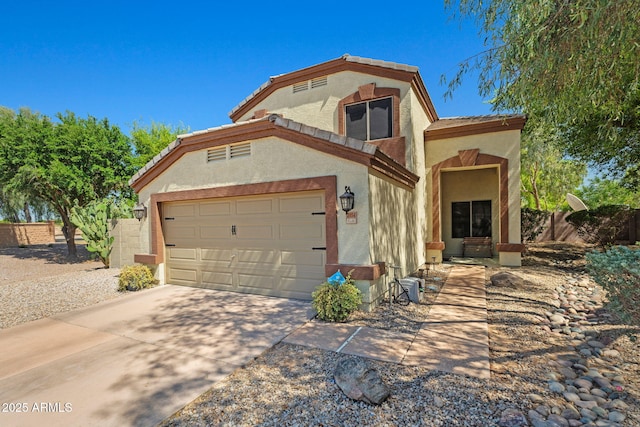 view of front facade with stucco siding, driveway, fence, a garage, and a tile roof