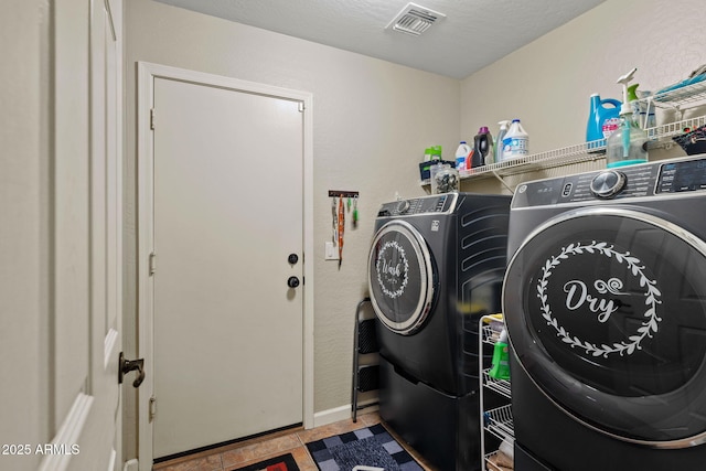 washroom with washer and dryer