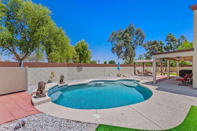 view of pool with ceiling fan, a fenced backyard, and a patio area