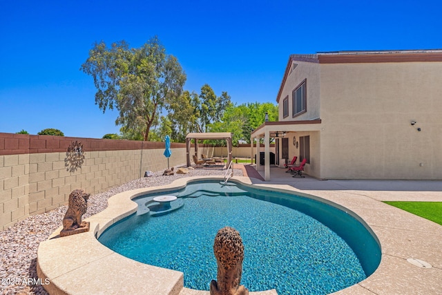 view of swimming pool featuring a fenced backyard and a patio area
