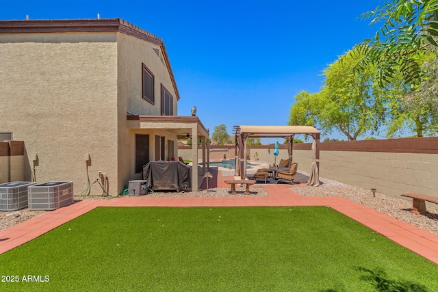 view of yard with central AC unit, a patio area, and ceiling fan