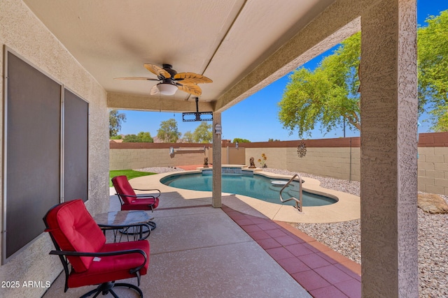 view of swimming pool featuring ceiling fan, a patio area, and a fenced backyard
