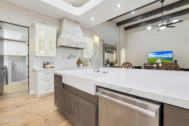 kitchen with white cabinetry, tasteful backsplash, dishwasher, light stone countertops, and light hardwood / wood-style floors