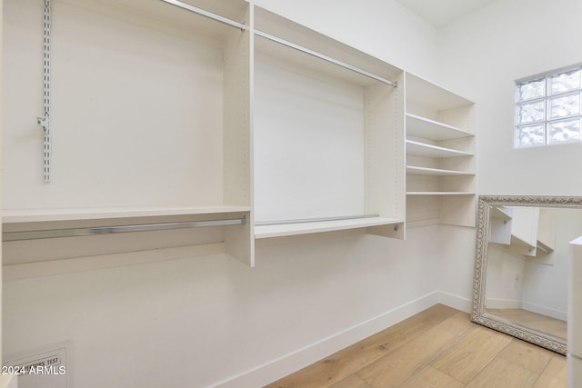 walk in closet with hardwood / wood-style floors