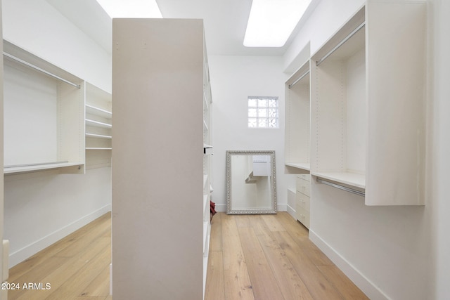 spacious closet with light hardwood / wood-style floors