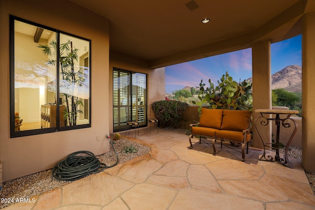 patio terrace at dusk with a mountain view