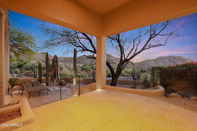 patio terrace at dusk with a mountain view