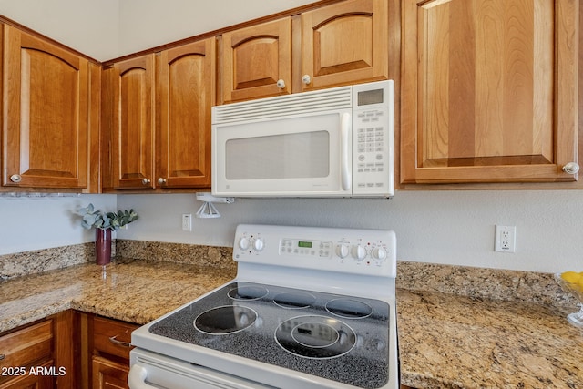 3649 E Hazeltine Way, Chandler, AZ 85249 - kitchen with white appliances, light stone countertops, and brown cabinetry