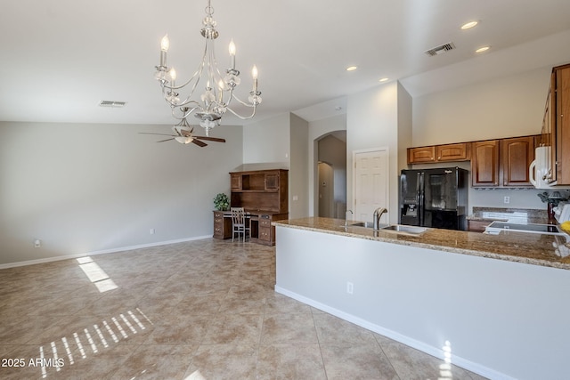 3649 E Hazeltine Way, Chandler, AZ 85249 - kitchen featuring black refrigerator with ice dispenser, arched walkways, a ceiling fan, a chandelier, and brown cabinets
