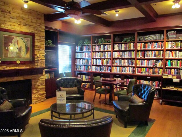 3649 E Hazeltine Way, Chandler, AZ 85249 - sitting room featuring bookshelves, beam ceiling, wood finished floors, ceiling fan, and coffered ceiling