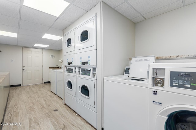 washroom featuring stacked washer and clothes dryer, separate washer and dryer, and light hardwood / wood-style floors