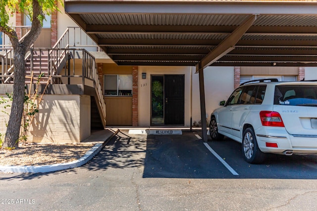 view of vehicle parking with a carport