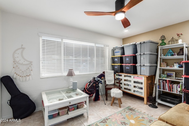 interior space with light tile patterned floors and ceiling fan