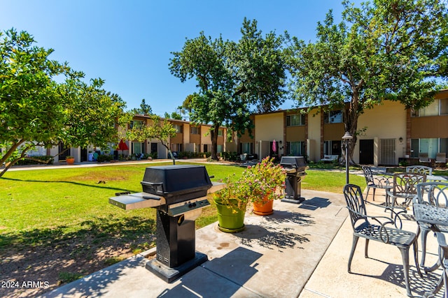 view of community featuring a patio and a yard