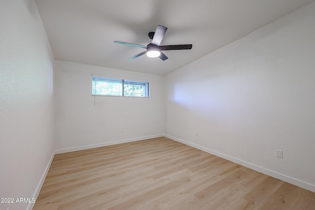 unfurnished room with baseboards, light wood-style floors, lofted ceiling, and ceiling fan