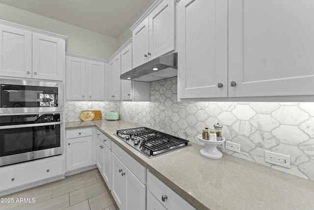 kitchen with stainless steel appliances and white cabinets