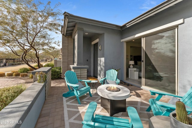 view of patio featuring an outdoor fire pit