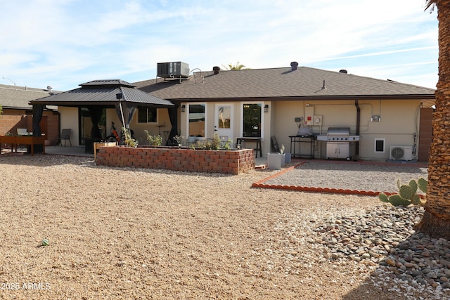 back of property with cooling unit, a gazebo, a patio area, and ac unit