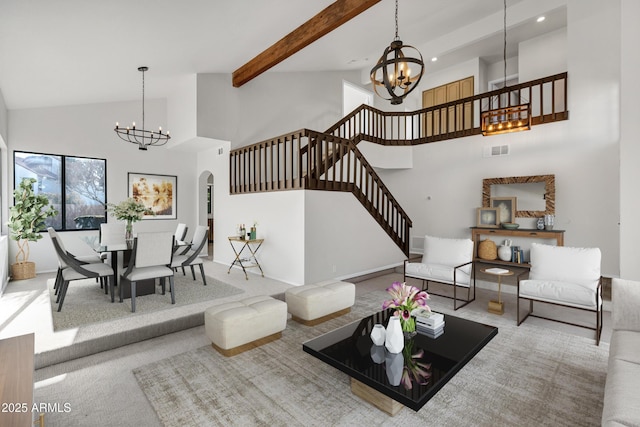 living room featuring a notable chandelier, a towering ceiling, and carpet