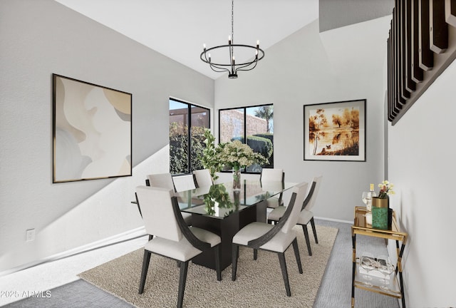 dining area with lofted ceiling, carpet floors, and a notable chandelier