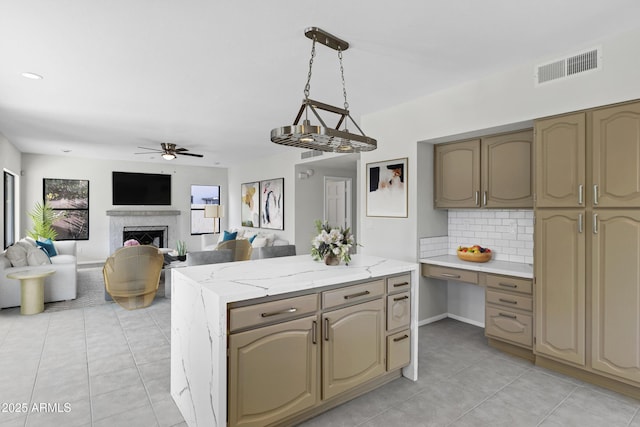 kitchen with ceiling fan, pendant lighting, tasteful backsplash, and light tile patterned flooring