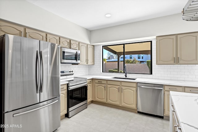 kitchen with sink, decorative backsplash, and stainless steel appliances