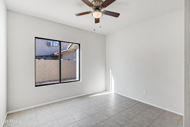 tiled spare room featuring ceiling fan