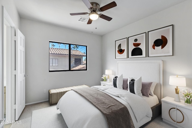 bedroom with ceiling fan and light carpet