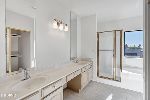 bathroom featuring shower with separate bathtub, vanity, and tile patterned flooring