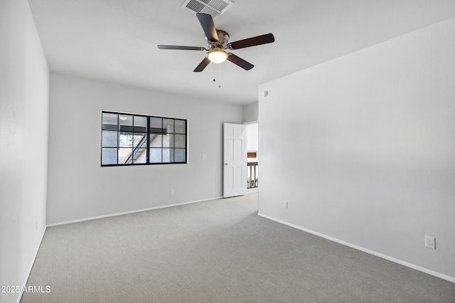 carpeted spare room with ceiling fan