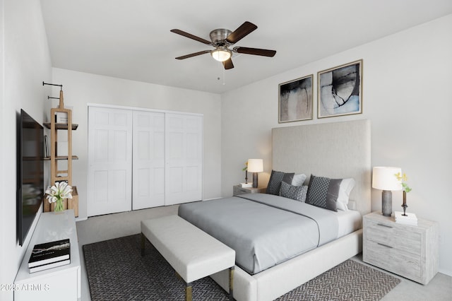 carpeted bedroom featuring a closet and ceiling fan