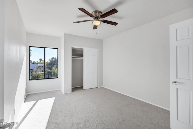 unfurnished bedroom featuring a closet, ceiling fan, and light carpet