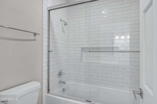 bathroom featuring toilet and enclosed tub / shower combo