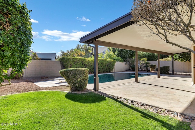 view of swimming pool with a lawn and a patio