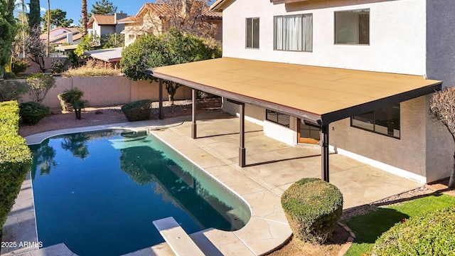 view of pool with a diving board and a patio