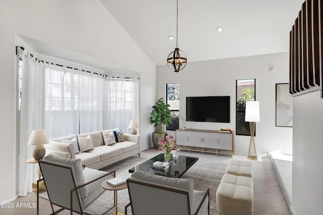 living room featuring high vaulted ceiling and a notable chandelier