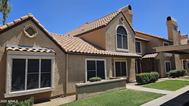 4601 N 102nd Ave Unit 1116, Phoenix, AZ 85037 - back of house featuring stucco siding and a tiled roof