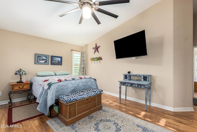 bedroom featuring hardwood / wood-style flooring, ceiling fan, and lofted ceiling