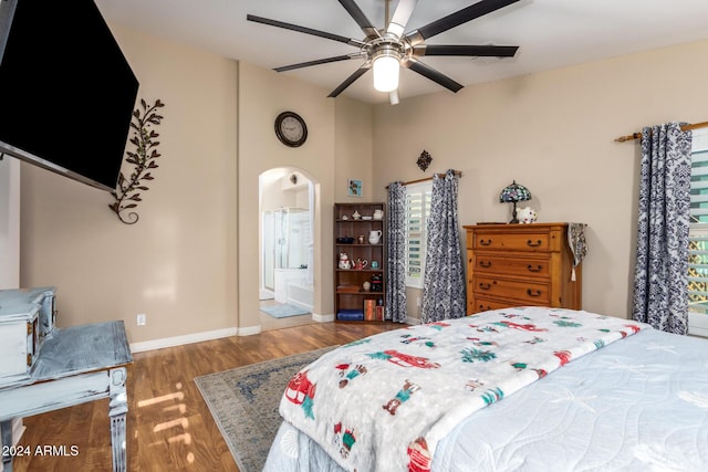 bedroom with ceiling fan, dark hardwood / wood-style flooring, and ensuite bathroom