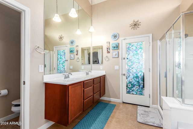 bathroom featuring tile patterned floors, vanity, and a shower with shower door