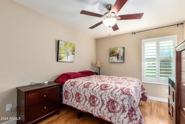 bedroom with ceiling fan and light wood-type flooring