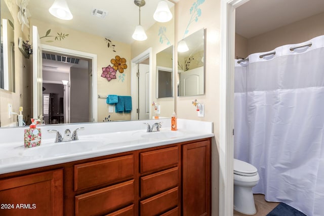 bathroom featuring tile patterned floors, vanity, and toilet