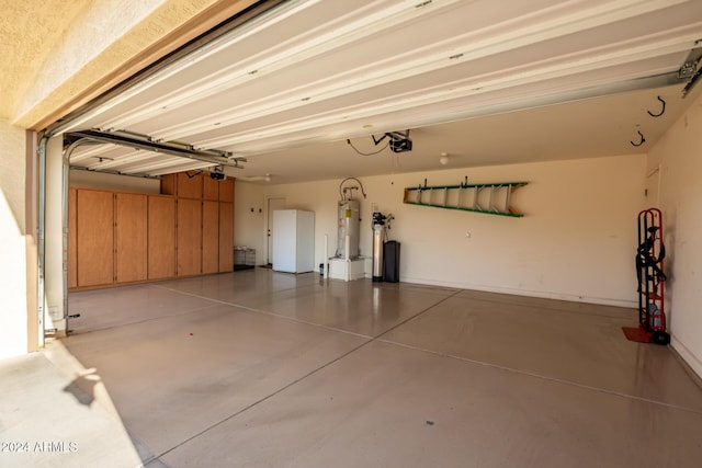 garage with a garage door opener and water heater