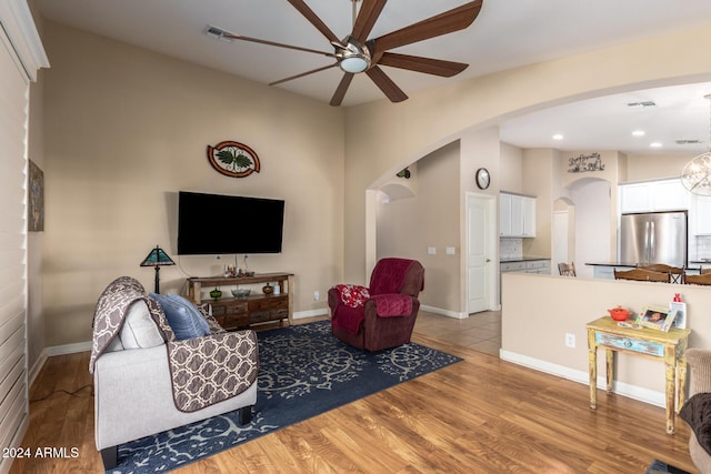 living room with light wood-type flooring and ceiling fan