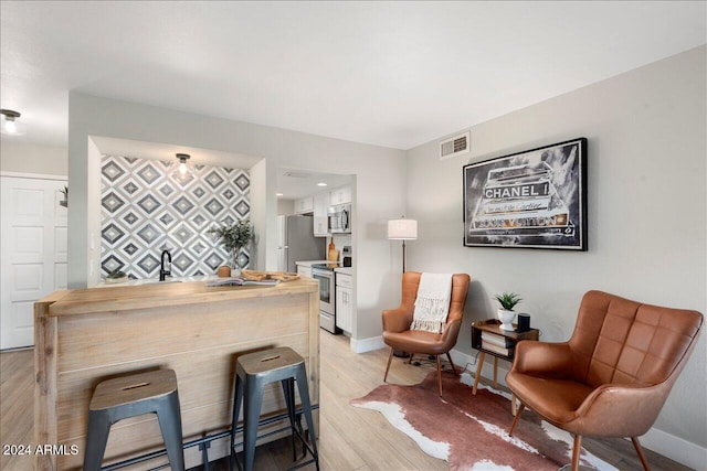 sitting room featuring light hardwood / wood-style flooring