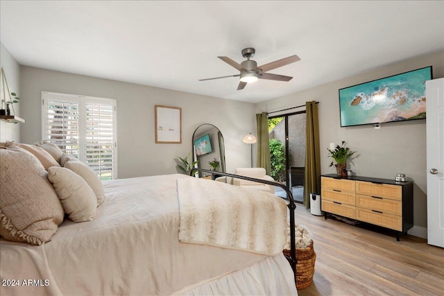 bedroom featuring ceiling fan, light hardwood / wood-style floors, and access to outside